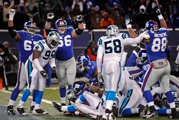 New York Giants' Kareem McKenzie, David Diehl and Michael Matthews signal touchdown as running back Brandon Jacobs, center, scores a touchdown during overtime to give the Giants a 34-28 win.